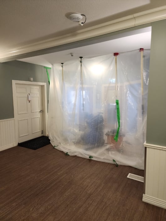 Hallway with construction plastic taped off at the end