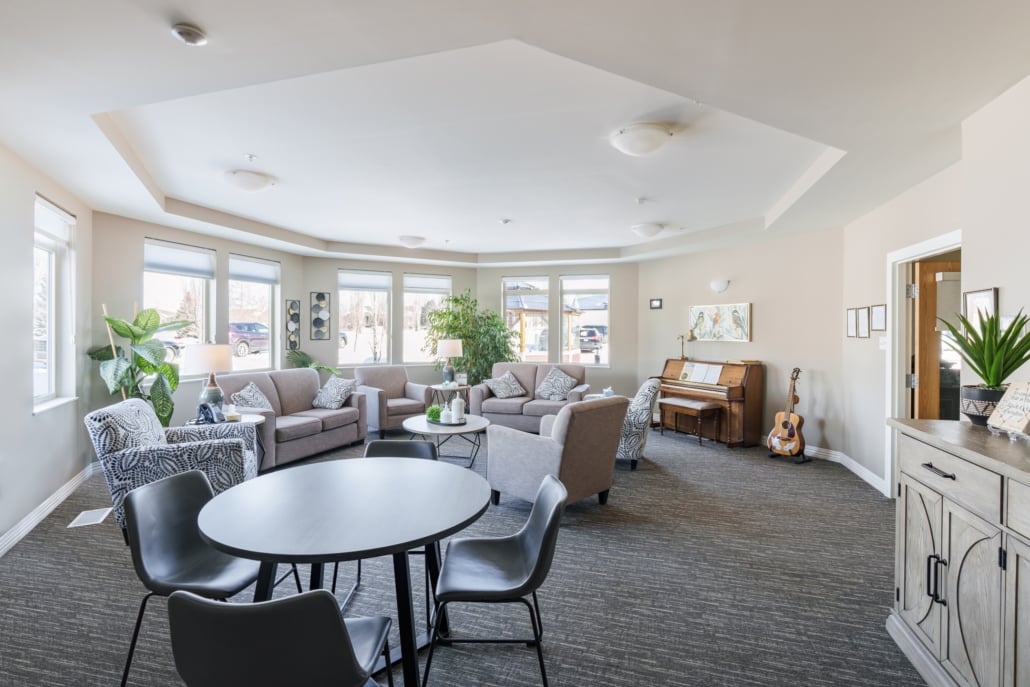Large Family Room with tables, chairs, comfy couches & musical instruments.