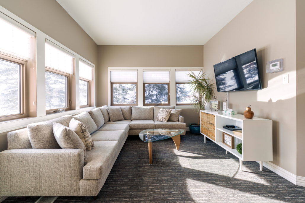 Sunny Family Room with sectional sofa, coffee table & television.