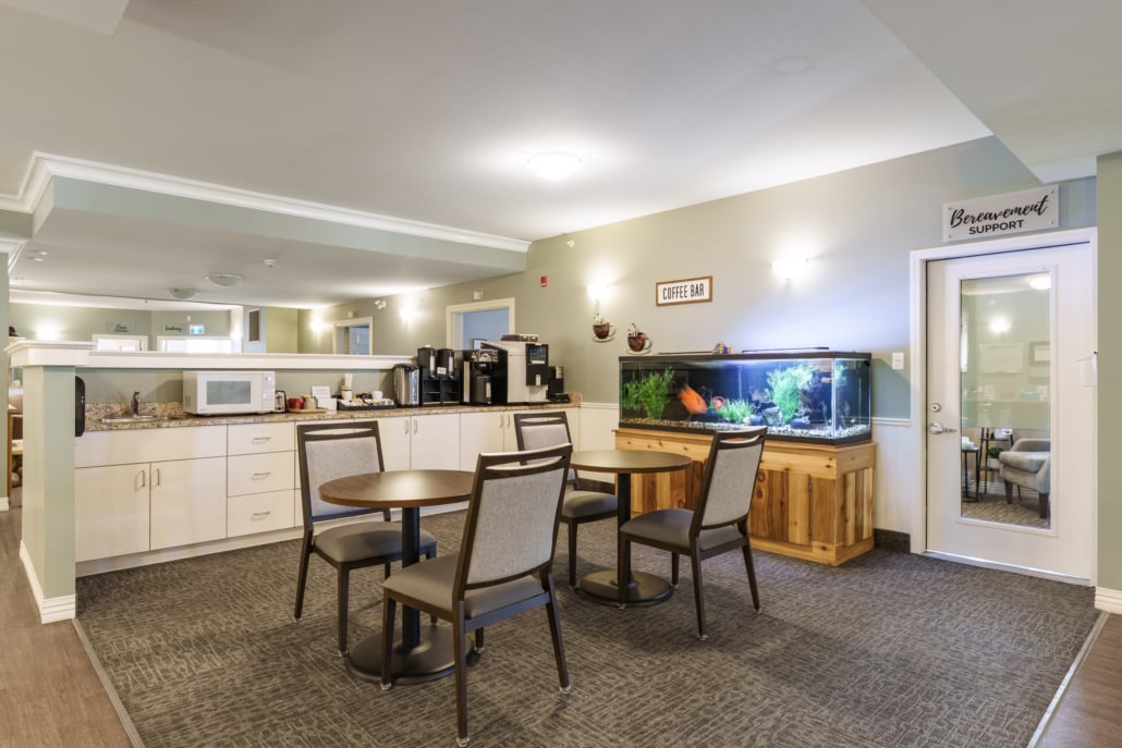 Cafe area with tables, chairs and a fish tank
